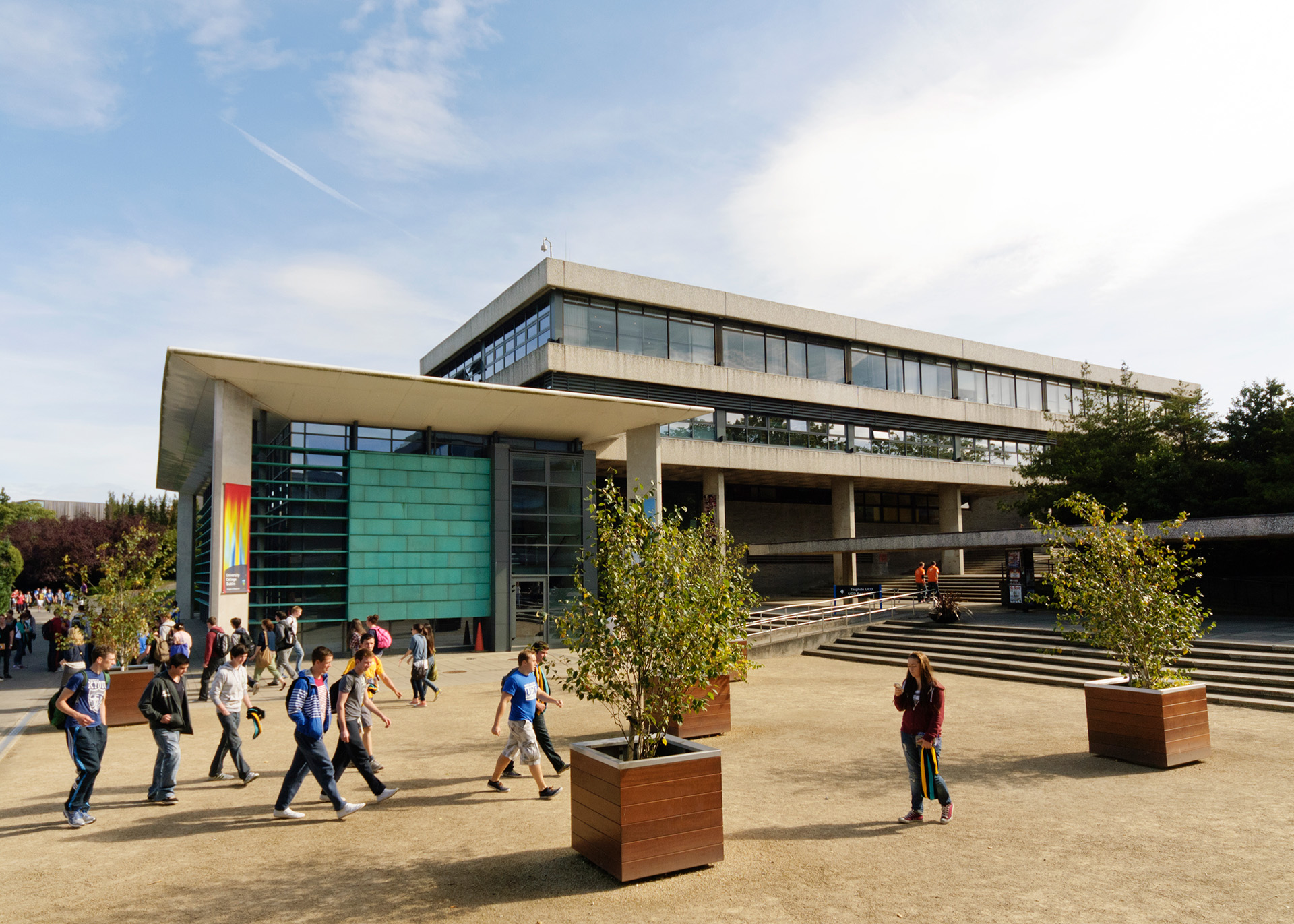 Students walking with UCD building in the background